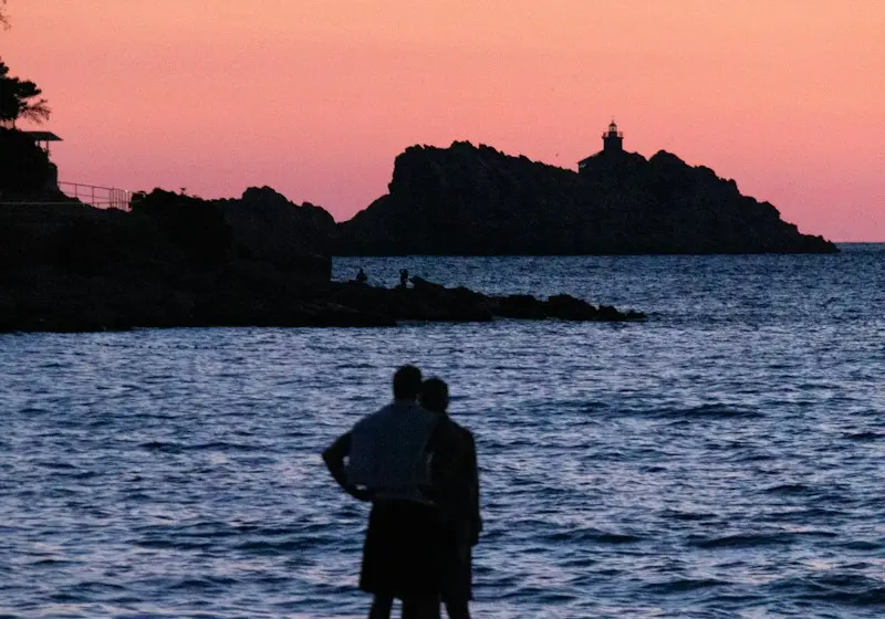 Couple silhouetted on a beach at sunset